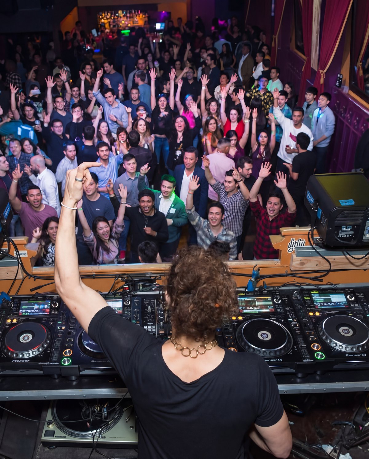 Lucas Morais in the DJ booth with a crowd cheering